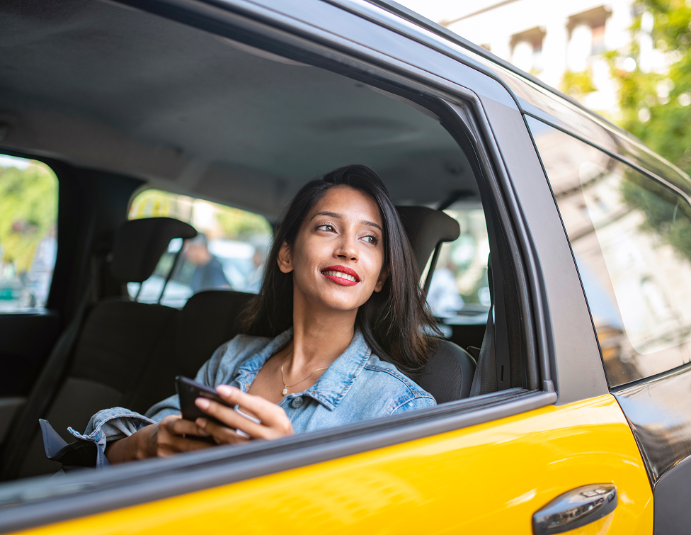 Passenger using phone in a cab